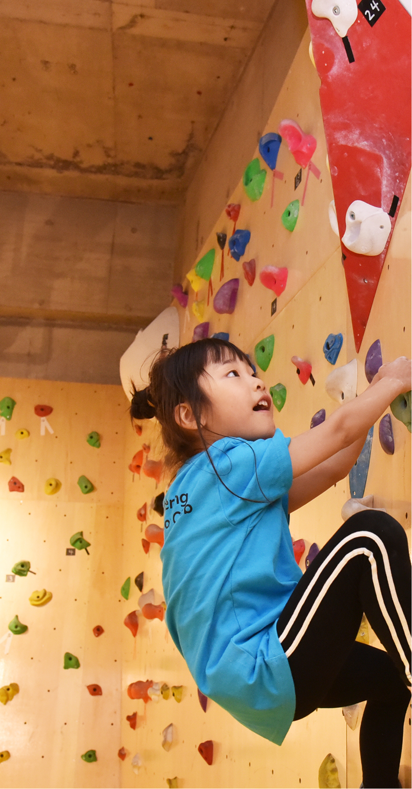 ボルダリングする子どもの写真